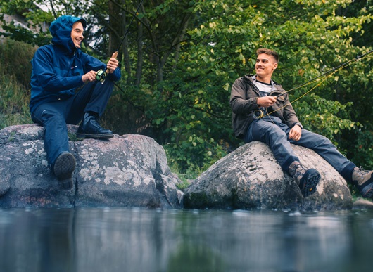Two men fishing and talking to each other
